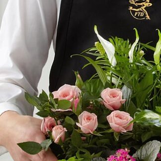 The Florist Designed Blooming and Green Plants in a Basket
