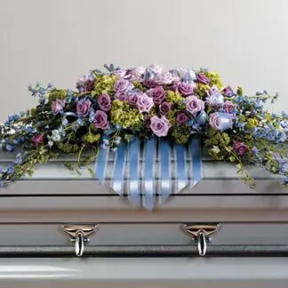 Sympathy Casket cover of soft lavenders. greens and blue